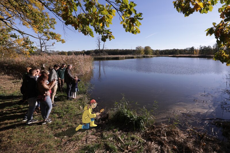 Fisherman Franzi with magnifying glass at the pond