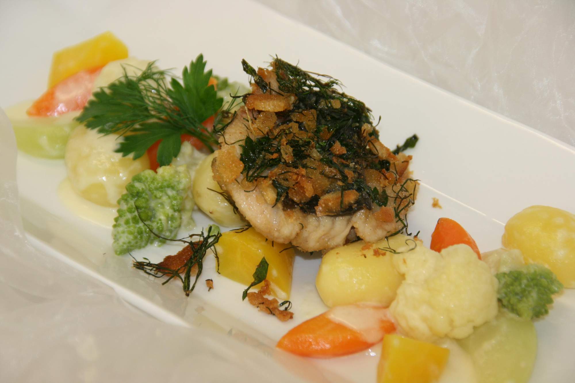 Carp schnitzel on creamed vegetables