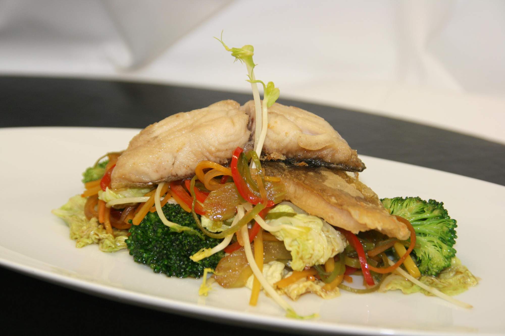 Fried carp on wok vegetables